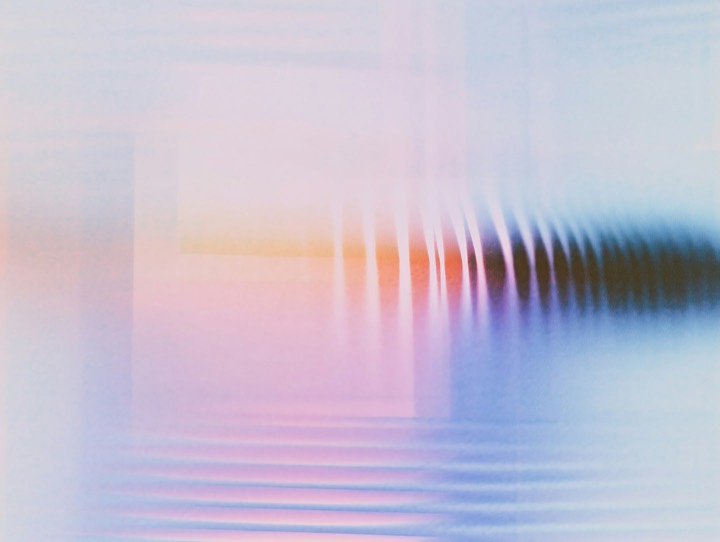 A soft abstract gradient in pink, orange and blue