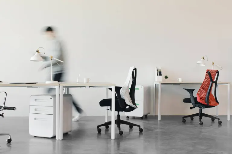 An empty office with a red desk chair